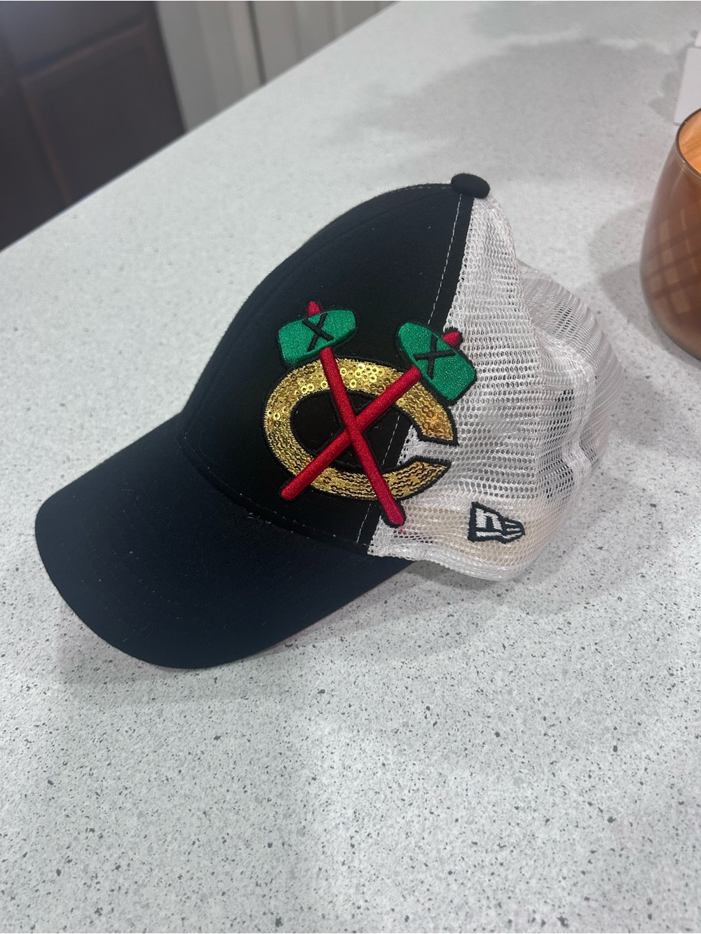 New Era Black & White Trucker Hat with Gold, Green & Red Patch
